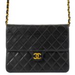 A Chanel black quilted lambskin single flap wallet shoulder bag.