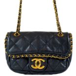 A Chanel black lambskin 'Chain Me' mini bag.