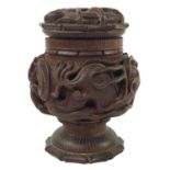 Ghurkha interest, A Nepalese carved teak tobacco jar and cover.