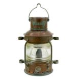 A small copper ship's anchor lantern.