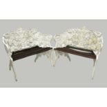 A pair of fern pattern white painted cast aluminium garden benches.