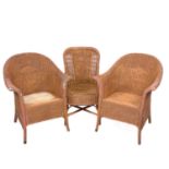 A pair of Lloyd Loom Lusty armchairs.