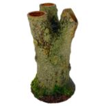 An earthenware tree trunk strawberry planter.