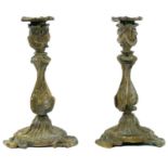A pair of French rococo brass candlesticks.