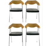 Four After Robin Day elbow chairs.