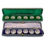 Two cased sets of six silver buttons.