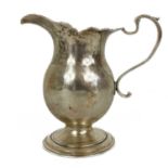 A Georgian silver provincial pedestal cream jug.