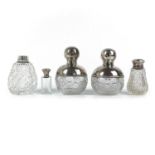 A pair of George V silver mounted cut glass ovoid scent bottles.