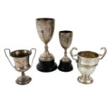 Four small hallmarked silver trophy cups.