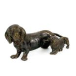 A silver plated bronze model of a Dachshund with puppy.