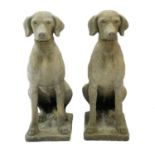 A pair of reconstitued stone figures of pointers.