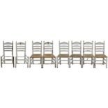A set of eight white-painted rush seated ladderback dining chairs.