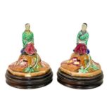 A pair of Majolica vase covers on stands.