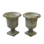 A pair of reconstituted stone garden urns.
