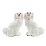 A pair of Victorian Staffordshire figures of seated spaniels.
