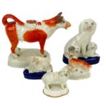 A Staffordshire pottery cow creamer and cover.