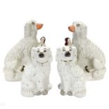 A pair of Victorian Staffordshire figures of oversized spaniels.