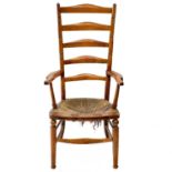 A Victorian beech framed ladderback kitchen armchair.