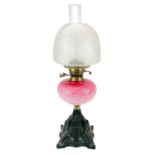 A Victorian brass oil lamp with etched glass shade.