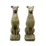 A pair of reconstituted stone figures of whippets.