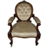 A Victorian walnut upholstered serpentine fronted open armchair.