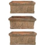 Three rectangular terracotta garden planters.