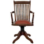 A teak swivel office chair.