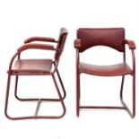 A pair of mid century steel tube frame armchairs.