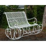 A wrought iron two seater garden rocking chair.