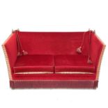 An upholstered two seater Knole type settee.