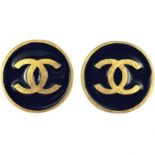 A Chanel pair of CC gold-tone and black enamel circular clip earrings.