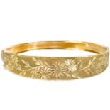 A 9ct gold hinged bangle.