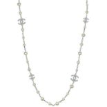 A Chanel white metal cultured pearl and white gem set CC long necklace.