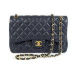 A Chanel Maxi navy blue caviar leather handbag.