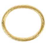 An 18ct gold Italian hinged hollow twist bangle.