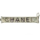 A Chanel light gold tone and gold calfskin leather logo bracelet.