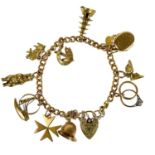 A 9ct gold charm bracelet applied with many charms.