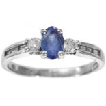 A modern 14ct white gold diamond and pale blue sapphire set ring.