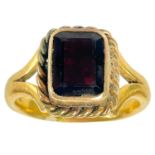 A Victorian 22ct and lower grade gold garnet set single stone ring.