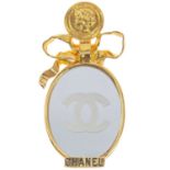 A Chanel gold-tone mirror brooch.