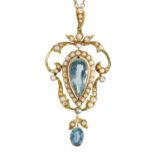An Art Nouveau gold openwork aquamarine and seed pearl set pendant.