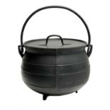 A cast iron cooking cauldron and cover.