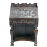 An unusual carved oak bureau.