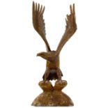 A wood carved eagle sculpture.