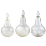 Three large late Victorian glass carbouys and stoppers.