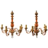 A pair of painted and gilt wood five branch chandeliers.
