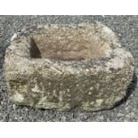 A rectangular granite trough.