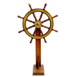 A brass mounted teak ship's wheel.
