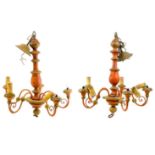 A pair of painted and gilt wood five branch chandeliers.