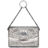 An Edwardian silver scroll engraved calling card purse by H Williamson Ltd.